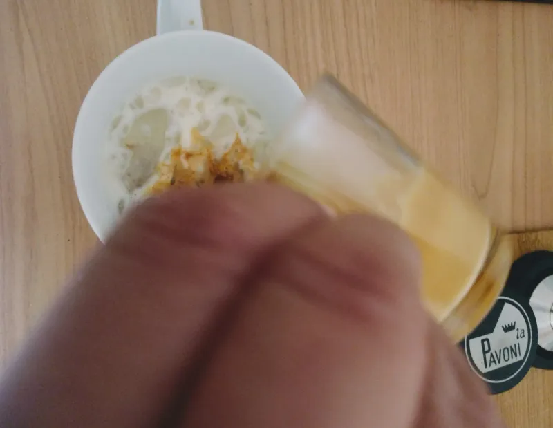 The espresso is poured into the cold milk