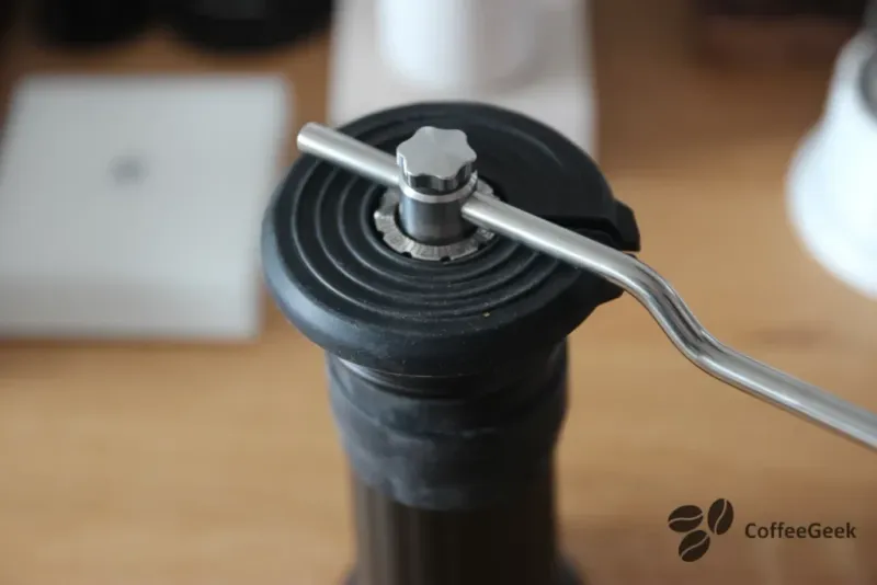 Pouring beans into the Apollo grinder hopper